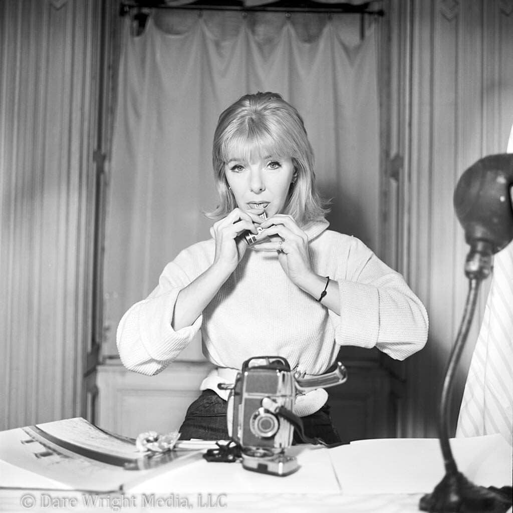 Image of Born in 1914, Dare Wright spent her early childhood with her mother, famed portrait artist Edith (Edie) Stevenson Wright. Edie treated Dare like a companion and the pair often created imaginary worlds through reading, writing, drawing, carpentry, and sewing. Dare loved to read Robin Hood, Grimms’ fairy tales, and The Lovely Garden, and she spent countless hours occupied by her dolls. Following Dare’s enrollment at Laurel boarding school in the fourth grade, Edith purchased Dare a 22-inch-tall Lenci doll on installment for $12.50 from the Halle Brothers Department Store. The doll wore a curly mohair wig, had flirty, side-glancing eyes, and sported an orange felt bonnet and organdy dress. Dare named the doll “Edith” after her mother. As most girls do with increasing age, Dare became preoccupied with other activities and eventually packed Edith into a trunk. In 1933, Dare graduated among the top five in her class. It doesn’t matter which version of Dare’s post-school life you read, because they all resemble a film script. She traveled internationally, modeled for Esquire, Cosmopolitan, and Maidenform, reconnected with her alcoholic brother Blaine, continued to play dress-up with her mother, and naively cast a spell on single and married men. Dare also converted a bathroom into a darkroom where she taught herself to process and develop film. Dare’s mother helped her develop an eye for artistic composition and she soon transitioned into a professional fashion photographer. In 1950, Edie was the midst of a move, and she began to send Dare trunks filled with her childhood belongings, including Edith. The doll became a primary subject of Dare’s photographs. The following year, Dare began to style her own blonde hair in a high ponytail with short bangs. Soon Edith sported the same look. Dare replaced Edith’s mohair wig with a false chignon wig and pierced her ears with delicate gold hoops. She sewed Edith white ruffled cotton underwear, a white eyelet petticoat, and a pink and white gingham dress. Dare also began to stage photographs of Edith with two teddy bears gifted to her by Blaine. The three playthings became the main characters of a children’s storybook about the adventures of a lonely doll and her two friends. In 1957, Doubleday and Company published Dare’s The Lonely Doll, a series of photographic illustrations featuring Edith and the bears. The simple text conveyed the story of a lonely doll who befriended Mr. Bear and Little Bear. Dare’s photographs were sophisticated, almost glamorous. The story conveyed childhood fear of punishment and loneliness, while exploring unconventional and unconditional love—themes that many critics believed ran rampant in Dare’s own life. The Lonely Doll quickly became a best-seller. In the October 13, 1957 edition of The New York Times, a literary critic noted that although Edith was a doll, “she seems in these photographs, lifelike too. Little girls will undoubtedly recognize their own moods in hers: her rainy-day crossness, her innocent mischief (dressing up in grown-up finery and lipstick), her contrition and final relief when all is forgiven.” Dare published nine more books in the Lonely Doll series. Dare and Edith became the subject of biographies, analysis of mother-daughter relationships, study of how photography mobilized the body and life through the figure of the doll, and idols for female artists such as Cindy Sherman and Kim Gordon. The pair also held a special place in the life of dollmakers. Several doll manufacturers made their own variations of Edith. The Alexander Doll Company produced the first version of Edith dressed in her signature pink and white gingham dress in 1958. The company obtained the license for the doll, again, in 2003 and turned out a version paired with a teddy bear for their Classics Collection. At a quick glance, Madame Alexander and Dare Wright seem an unlikely pair. Madame Alexander presented herself as demure, while Dare posed freely in the nude. But the two both proved to be ambitious, detail-oriented, and free from conventional norms. They had a passion for play and for using their talents to foster a child’s imagination. You can see this for yourself in the new display, 100 Years of Madame Alexander, at The Strong National Museum of Play.