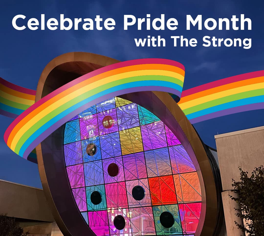 Colorful windows of the Adams Atrium with a rainbow ribbon and text reading "Celebrate Pride Month with The Strong"