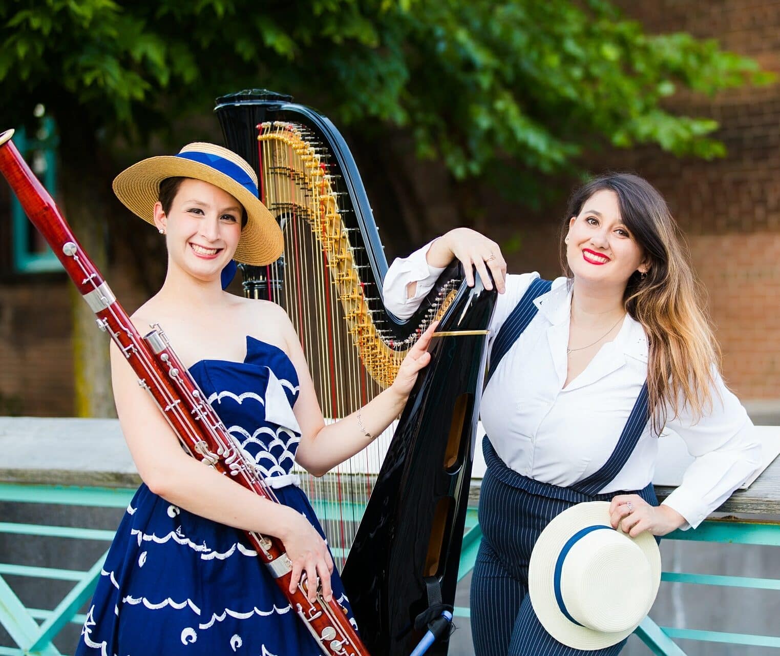 two musicians standing with a harp and oboe