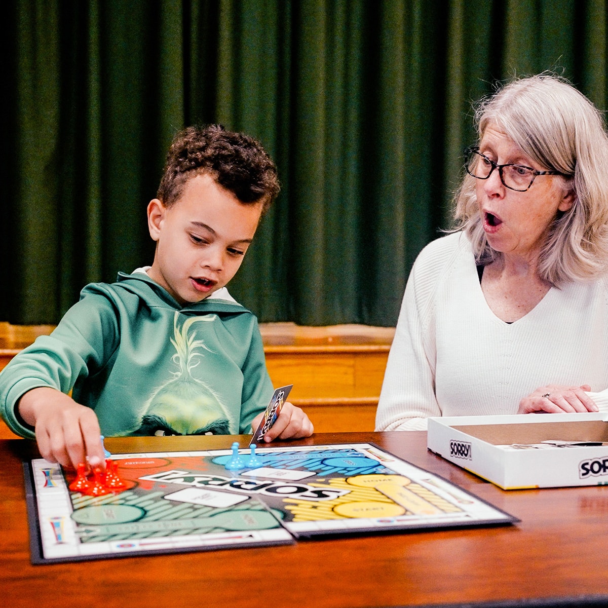 Adult with young boy playing Sorry