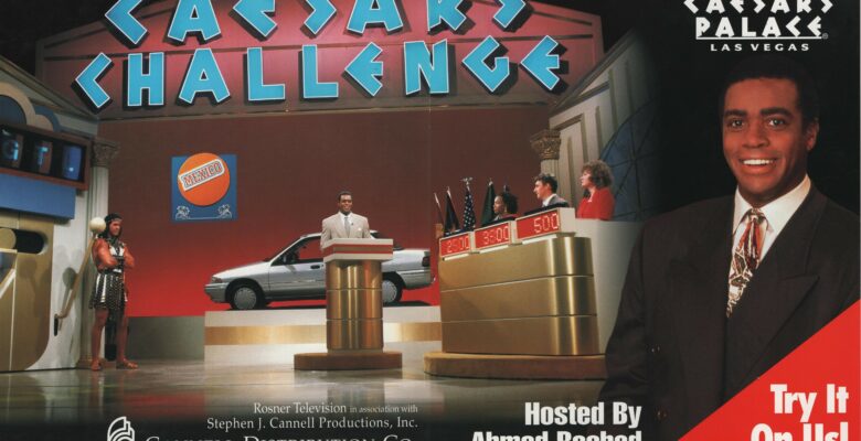 Promotional graphic for Caesars Challenge featuring the name of the show and a picture of the set, complete with the host at a podium and three contestants